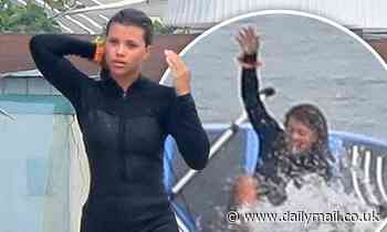 Sofia Richie dons a short wetsuit as she wipes out while paddleboarding...after Scott Disick split
