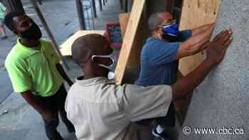 Residents flee, batten down as dual storms approach U.S. Gulf Coast