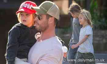 Chris Hemsworth carries injured son with bandages on his hands in Byron Bay - Daily Mail