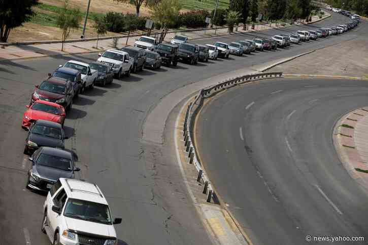 Long delays at U.S.-Mexico border crossings after new travel restrictions