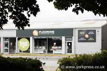 Flooring store aids charity with donation
