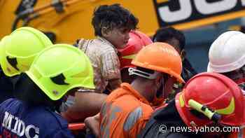 India building collapse: 13 dead as search for survivors continues