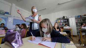 Europe's children return to school packing textbooks and, for many, face masks