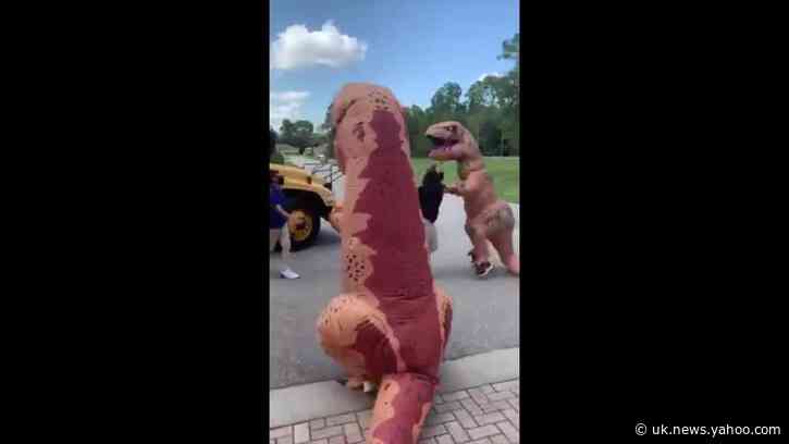 Dino-Mite Foster Parents Embarrass Teens by Meeting Them at Bus Stop in T-Rex Costumes