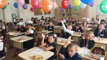 Temperature checks and no masks: School is back in Russia, but classes look much the same