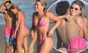 Sofia Richie wears a pink bikini as she frolics in the surf with Jaden Smith before a double date