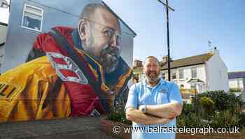 RNLI volunteer honoured for 40 years of service with mural looking out to sea
