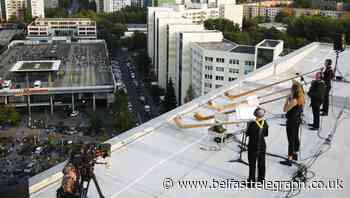 Rooftop alphorns power virus-safe concert in Germany