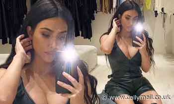 Kim Kardashian wears low-cut romper with knee-high boots for selfie