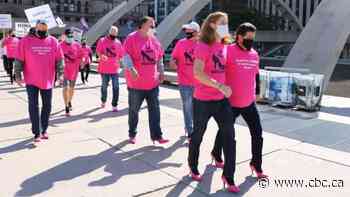 Members of Unifor walk in pink high heels downtown to raise money for women's shelter