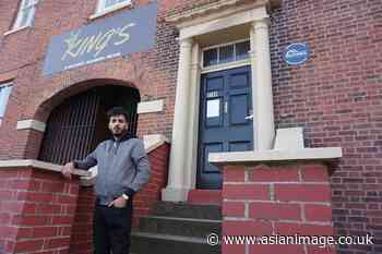 Young entrepreneur leading renovations to historic building in town centre - Asian Image