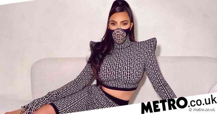 Kim Kardashian becomes a Balmain Barbie as she models vintage two-piece with matching face mask