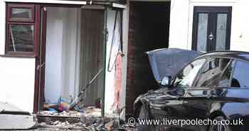 BMW smashes into house after flattening lamp-post and wall