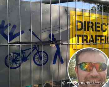 York man 'disgusted' by image on sign showing cyclist being hit with a baseball bat