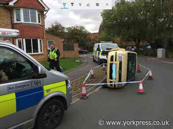Police probe after car 'pushed onto its side by yobs'