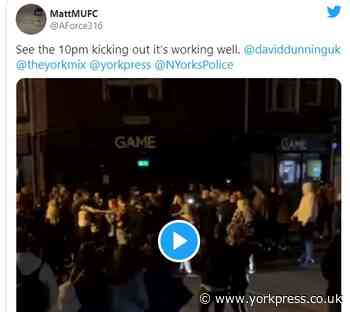 Milling crowds sing and chant after pubs shut at 10pm