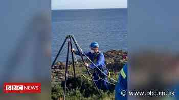 Coastguard rescue young girl from cliff ledge