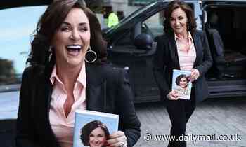 Shirley Ballas looks stylish in a black suit and a pink shirt