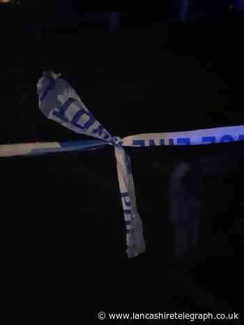 Crowd members cut police tape after crash in Accrington