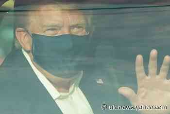Donald Trump waves to supporters from car on brief departure from hospital