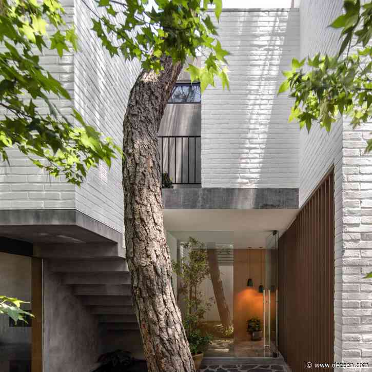 White-brick walls wrap trees and patios to form Casa RA in Mexico