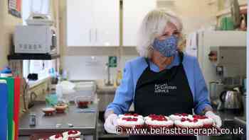 Camilla praises volunteers as she serves lunch to pensioners