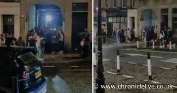 Shocking footage shows crowd flout Covid rules by hugging and dancing in street