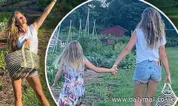 Gisele Bundchen picks fresh food from a garden with her daughter Vivian
