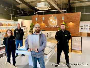 York flooring store hands donation to homelessness charity