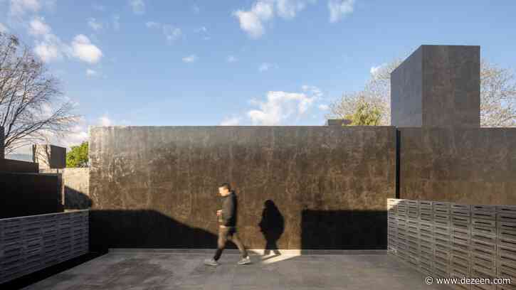 Black monolithic volumes and concrete latticework form Carrizal houses in Mexico City