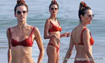 Alessandra Ambrosio puts sensational bikini body on display as she gambols in the ocean