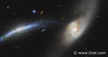 Hubble spots wild cosmic 'waterspout' as two galaxies get cozy     - CNET