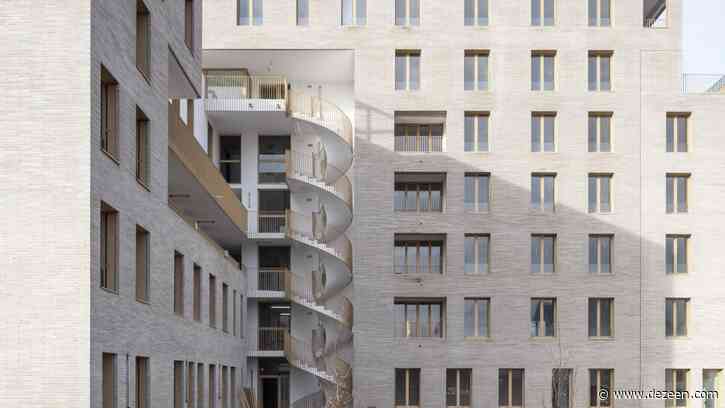 Spiral staircase twists through Zellige apartment complex by Tectône and Tact Architectes