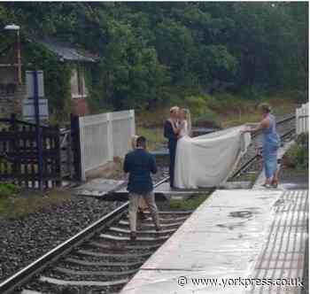 Couple posed for wedding photos on railway track near Whitby
