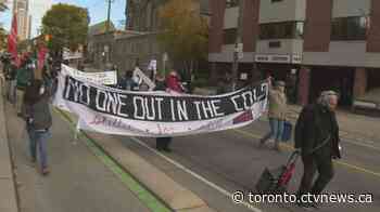 Protesters rally for vacant downtown Toronto properties to be turned into social housing