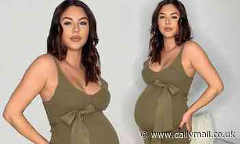 Pregnant Shelby Tribble displays her blossoming baby bump in a dark green dress