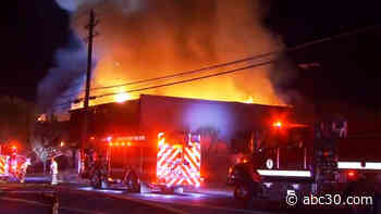 Roadway closed as crews battle large fire at Madera building