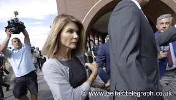 Actress Lori Loughlin reports to prison in college scam