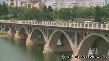 City crews installing seasonal decorations on Saskatoon bridges this week