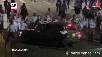 Police smash car windows, family trapped at protest