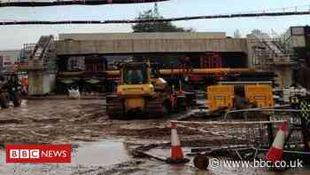 Lorries moving new railway bridge stuck in mud