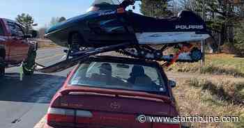 Wisconsin trooper pulls over two vehicles at once: a Minnesota car and the snowmobile on the roof