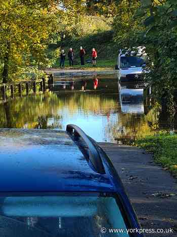 Van stuck in flood water in Poppleton