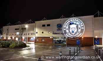 Wigan Warriors club badge projected on Halliwell Jones Stadium - Warrington Guardian