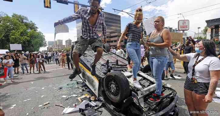 Two men get community service, fines for flipping police car during May protest