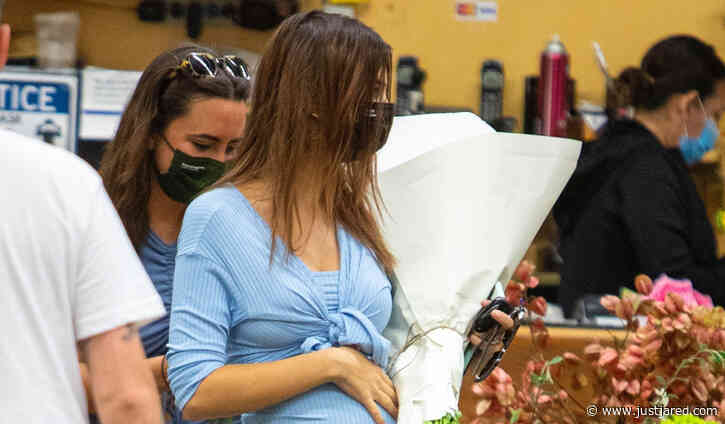 Emily Ratajkowski Cradles Her Growing Baby Bump While Shopping for Flowers