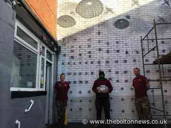 Poignant mural created outside The Para Cafe in Bolton