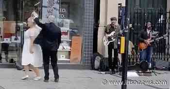 Video: Newlywed couple dance to buskers in Belfast city centre - The Irish News