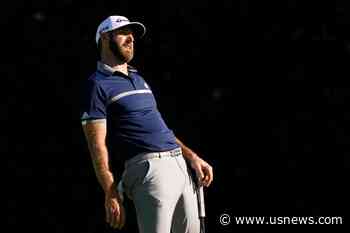The Latest: Johnson Shares Masters Lead, Play Suspended