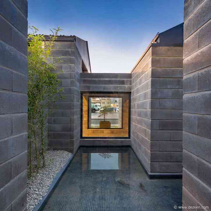 Hooba Design Group arranges concrete showroom in Iran around fish pond and greenery